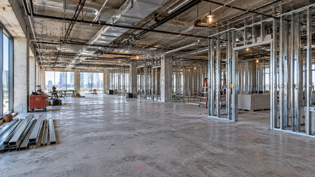 Light-gauge metal stud partitions framed across an open office floor